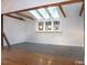 Bright living space with skylights, beams, hardwood floors, and windows offering views of the outdoors at 915 Phils Creek Rd, Chapel Hill, NC 27516
