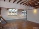 Open-concept living room with wood floors, exposed beams, and skylights for an airy feel at 915 Phils Creek Rd, Chapel Hill, NC 27516