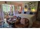 Bedroom with an artist studio, leather chairs and striped bedding at 915 Phils Creek Rd, Chapel Hill, NC 27516