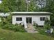 Exterior view of weathered outbuilding with overgrown landscaping at 915 Phils Creek Rd, Chapel Hill, NC 27516