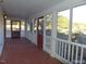 Inviting screened porch with white railings, showcasing access doors and a view of the beautiful outdoors at 915 Phils Creek Rd, Chapel Hill, NC 27516