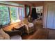 Comfortable sitting area with wicker chairs, hardwood floors, and a bright window at 915 Phils Creek Rd, Chapel Hill, NC 27516