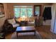 Cozy sitting area with wicker chairs, wooden table and floors, plus a sunlit window view at 915 Phils Creek Rd, Chapel Hill, NC 27516