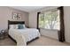 Bright bedroom with a comfortable bed, neutral walls, and a large window offering natural light at 102 Rosebrooks Dr, Cary, NC 27513