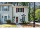 Charming townhome with white siding, red shutters, and well-manicured landscaping at 102 Rosebrooks Dr, Cary, NC 27513