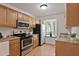 Bright kitchen featuring stainless steel appliances, light cabinets, and a window offering natural light at 102 Rosebrooks Dr, Cary, NC 27513