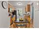 Cozy eat-in kitchen featuring warm wood cabinets, modern appliances, and a charming window for natural light at 102 Rosebrooks Dr, Cary, NC 27513