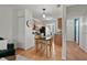 Modern kitchen with wooden cabinets and a breakfast table next to the living room area at 102 Rosebrooks Dr, Cary, NC 27513