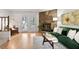 Bright living room boasts a stone fireplace, wood floors, and access to outdoor space at 102 Rosebrooks Dr, Cary, NC 27513