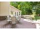 Back deck with metal chairs and an umbrella-shaded glass table for outdoor entertaining at 104 Crossway Ln, Holly Springs, NC 27540
