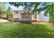 Expansive backyard with a lush lawn and mature trees, perfect for recreation and relaxation at 104 Crossway Ln, Holly Springs, NC 27540