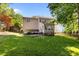 Expansive backyard featuring a well-maintained lawn and complemented by mature trees and a charming sunroom extension at 104 Crossway Ln, Holly Springs, NC 27540