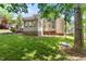 Expansive backyard with a lush lawn and mature trees, perfect for recreation and relaxation at 104 Crossway Ln, Holly Springs, NC 27540