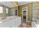 Bright bathroom featuring double sinks, a glass enclosed shower, and ceramic tile floors at 104 Crossway Ln, Holly Springs, NC 27540