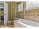 Elegant bathroom featuring a shower, soaking tub, and modern tile work at 104 Crossway Ln, Holly Springs, NC 27540