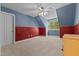 Cozy bedroom features blue and red walls, plush carpeting, and a ceiling fan at 104 Crossway Ln, Holly Springs, NC 27540