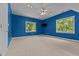 Bedroom showcasing neutral carpet, blue walls, and two windows providing ample natural light at 104 Crossway Ln, Holly Springs, NC 27540