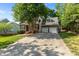 Wide concrete driveway leading to the charming brick home with a spacious two-car garage at 104 Crossway Ln, Holly Springs, NC 27540