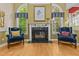 Living room showcasing a fireplace flanked by windows, creating a cozy ambiance at 104 Crossway Ln, Holly Springs, NC 27540