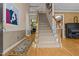 Elegant foyer featuring hardwood floors, a staircase, and classic decor at 104 Crossway Ln, Holly Springs, NC 27540