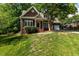 Traditional brick home with manicured lawn, mature trees, and a welcoming entrance at 104 Crossway Ln, Holly Springs, NC 27540