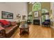 Cozy living room with a vaulted ceiling, fireplace, hardwood floors, and ample seating at 104 Crossway Ln, Holly Springs, NC 27540