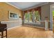 Open room with hardwood floors, large windows, and a neutral color palette at 104 Crossway Ln, Holly Springs, NC 27540