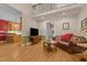 Bright living room with hardwood floors, a comfortable leather sofa, and easy access to the kitchen at 104 Crossway Ln, Holly Springs, NC 27540