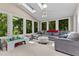 Bright sunroom with skylights, many windows, and a comfortable seating area at 104 Crossway Ln, Holly Springs, NC 27540
