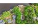 An aerial view highlighting the property's landscaping, mature trees, and lake access at 104 Pontiac Cv, Louisburg, NC 27549