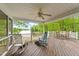 Spacious deck with rocking chairs, outdoor seating, and a picturesque lake view at 104 Pontiac Cv, Louisburg, NC 27549