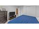 Spacious bedroom with a closet, dark dresser, and a TV at 104 Pontiac Cv, Louisburg, NC 27549