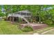 Charming lake house featuring a screened porch, spacious deck, and a brick patio at 104 Pontiac Cv, Louisburg, NC 27549