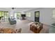 Bright living room with carpet, and sliding glass doors to the deck at 104 Pontiac Cv, Louisburg, NC 27549