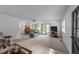 Open living room with ceiling fan, carpet, and sliding glass doors to the outdoors at 104 Pontiac Cv, Louisburg, NC 27549