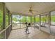 Screened-in porch with exercise equipment, leading to a spacious back deck with lake views at 104 Pontiac Cv, Louisburg, NC 27549