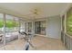 Inviting sunroom with tile flooring, ceiling fan, and sliding glass doors to the deck at 104 Pontiac Cv, Louisburg, NC 27549