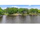 Lakeside home featuring a private boat dock, beautifully landscaped lawn, and serene water views at 104 Pontiac Cv, Louisburg, NC 27549