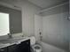 Bathroom with black vanity, toilet, and shower-tub combination at 105 Blue Bay Ln, Cameron, NC 28326