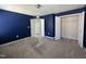 Spacious carpeted bedroom features an open closet and a blue accent wall at 105 Blue Bay Ln, Cameron, NC 28326