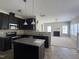 Stylish kitchen with stainless steel appliances, granite countertops, and dark cabinets at 105 Blue Bay Ln, Cameron, NC 28326