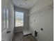 Laundry room with tile floors, a window, and shelving at 105 Blue Bay Ln, Cameron, NC 28326