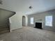 Spacious living room featuring neutral paint, plush carpet, a fireplace, and staircase at 105 Blue Bay Ln, Cameron, NC 28326
