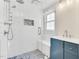 Modern bathroom featuring a glass-enclosed shower with hexagon tile and a blue vanity at 105 N 11Th St, Erwin, NC 28339