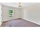 Neutral carpeted bedroom with window view, paint, and chandelier lighting at 105 N 11Th St, Erwin, NC 28339