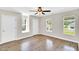 Bright bedroom with hardwood floors, natural light, neutral paint, and ceiling fan at 105 N 11Th St, Erwin, NC 28339