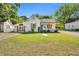 Charming white home with inviting curb appeal, featuring a manicured lawn and contrasting wood accents at 105 N 11Th St, Erwin, NC 28339