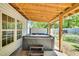 Cozy covered hot tub area with wooden beams and concrete patio at 105 N 11Th St, Erwin, NC 28339