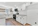 Bright kitchen with white cabinets, stone countertops, stainless steel appliances and wood grain flooring at 105 N 11Th St, Erwin, NC 28339