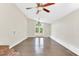 Spacious living room featuring hardwood floors, natural light, neutral paint, and ceiling fan at 105 N 11Th St, Erwin, NC 28339